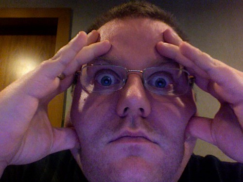 Kevin holding his head in his hands.