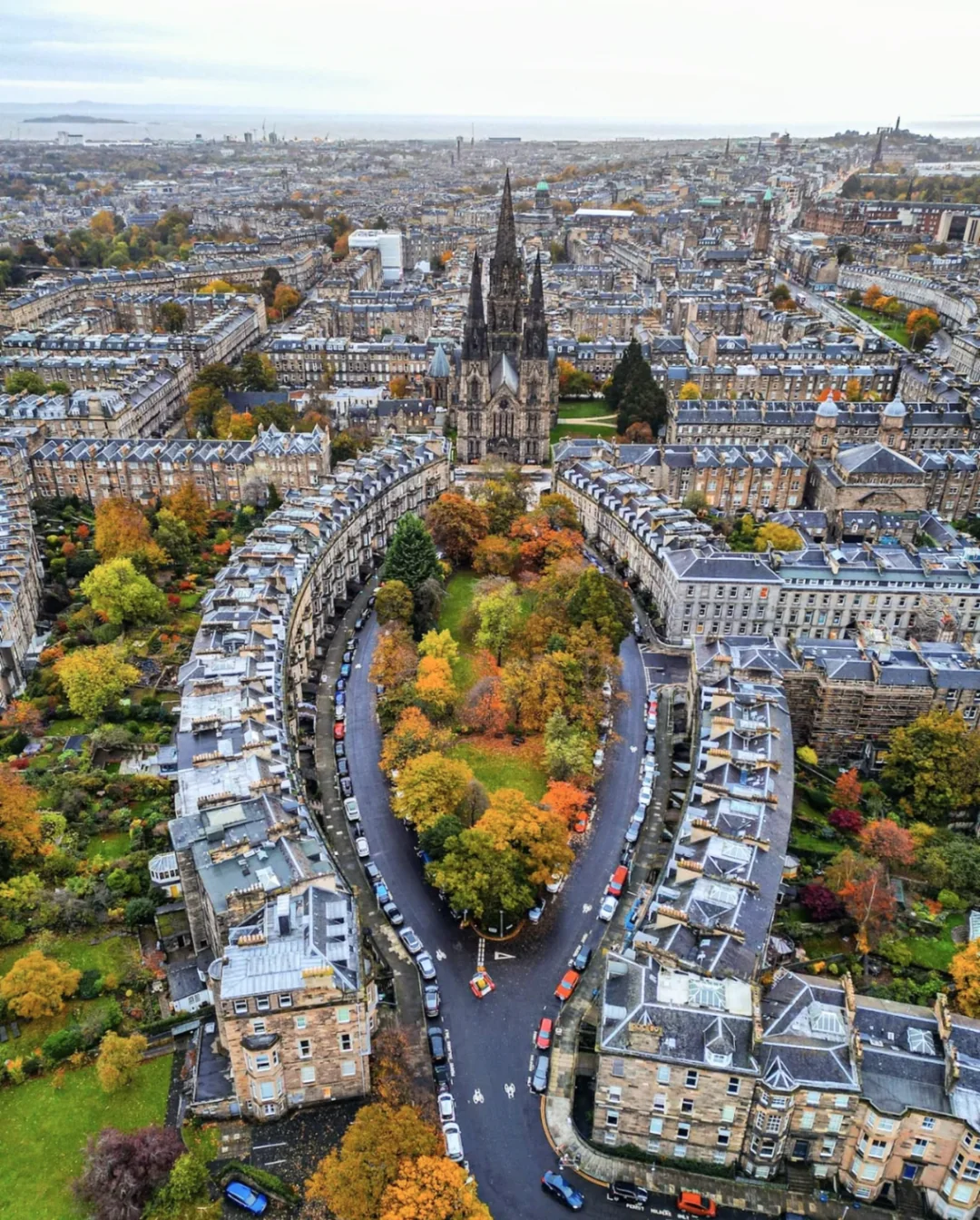 An aerial photograph of an avenue in edinburgh. The street curves around an oval of woodland, and then meets again at a church in the distance. The whole image vaguely looks vaginal (and given the Victorians, maybe intentionally so) and the church is positioned roughly where the clitoris would be, if it existed.