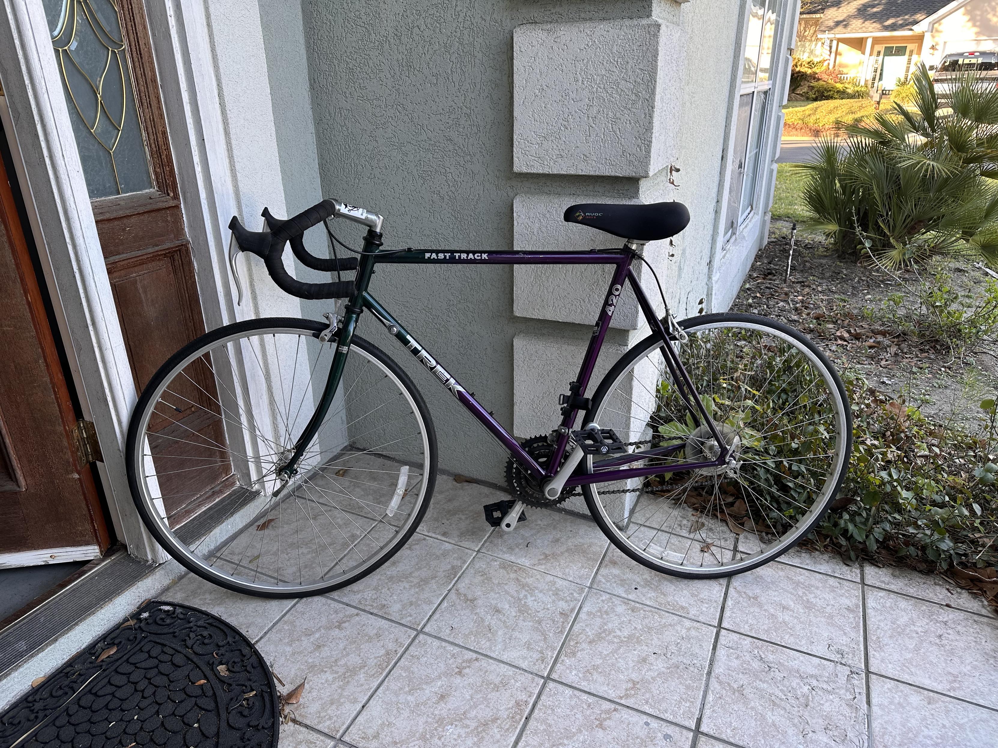 A Trek 420 Fast Track bicycle leaning against a house. It looks ready to ride. 