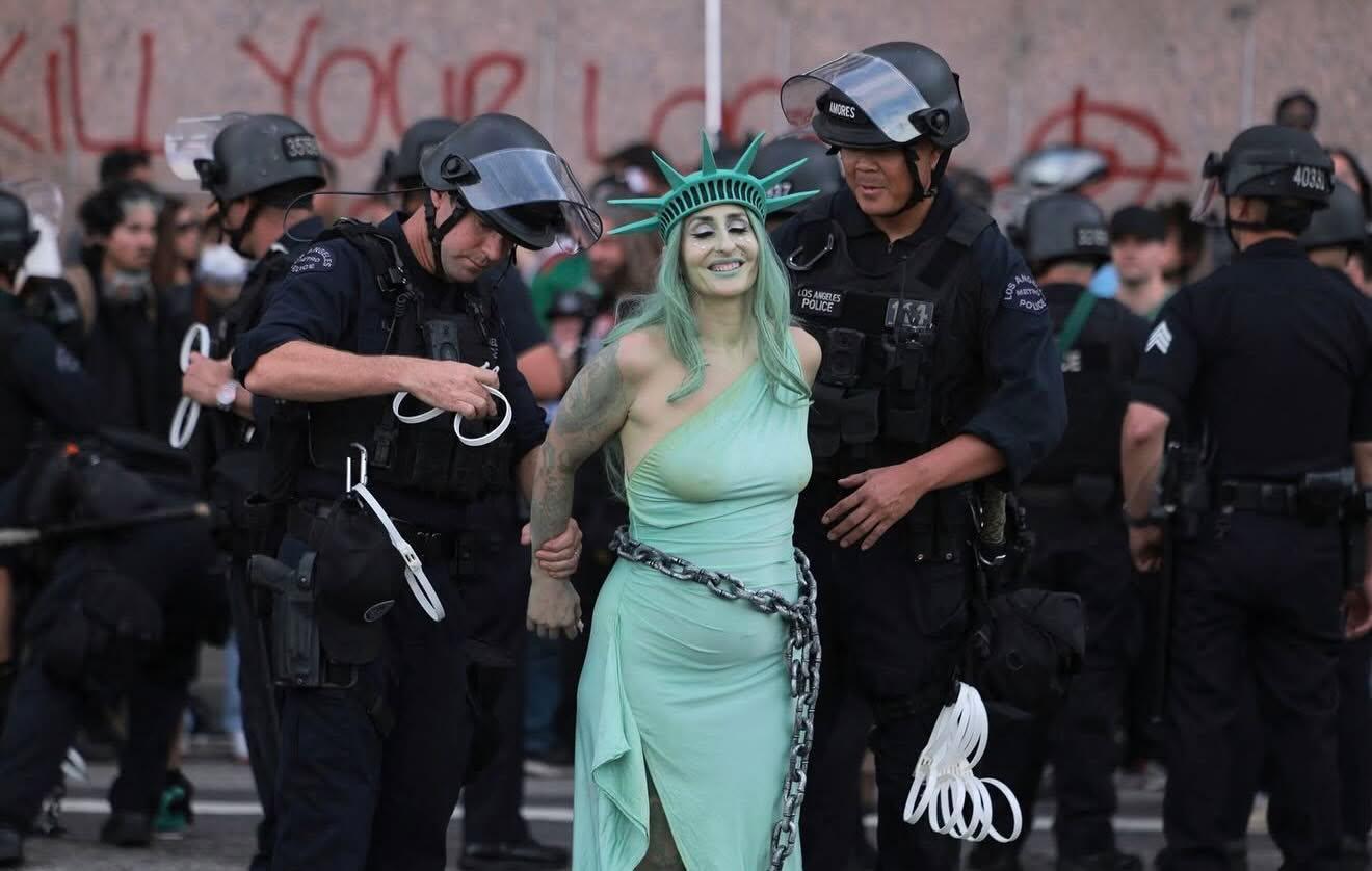 Cops handcuffing Lady Liberty