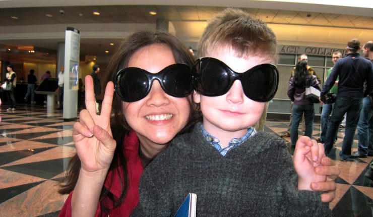 Cindy Li and Brian posing with silly glasses